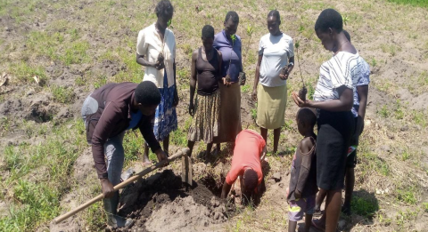 An MDFA extension officer demonstrates pitting and planting of trees in degraded land in Uganda’s Moyo district (Courtesy of MDFA)