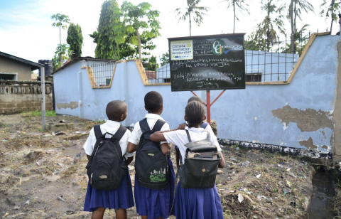 Karakata school, children read the expected rainfall, temperatures and weather conditions on a community chalkboard (Courtesy of DARAJA)