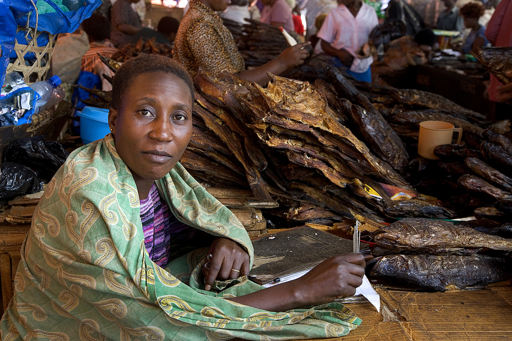 A woman sells dried fish in Kampala's Owino Market, which sprawls around an old stadium downtown