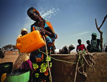 A woman refills her bucket from a well in Natriguel, Mauritania