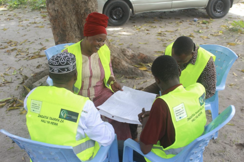 A team of community members meet to discuss the five-day weather forecast from Tanzania Meteorological Authority. They will simplify it into a short, easy-to-understand weather SMS to be sent to the community in Karakata informal settlement in Dar es Salaam, Tanzania (Courtesy of DARAJA)