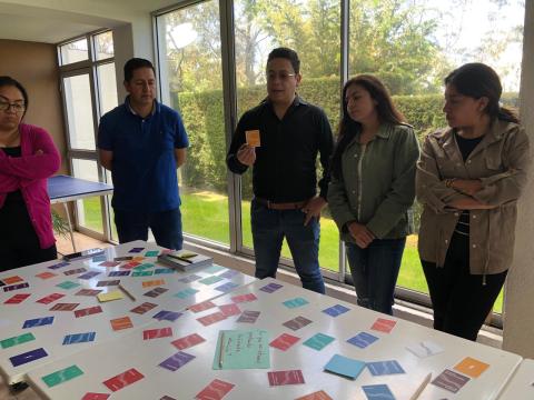 Participants in Latin America playing the card game