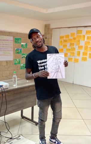 Julius Obisa (Obi) holding a drawing of the knowledge broker he aspired to become.