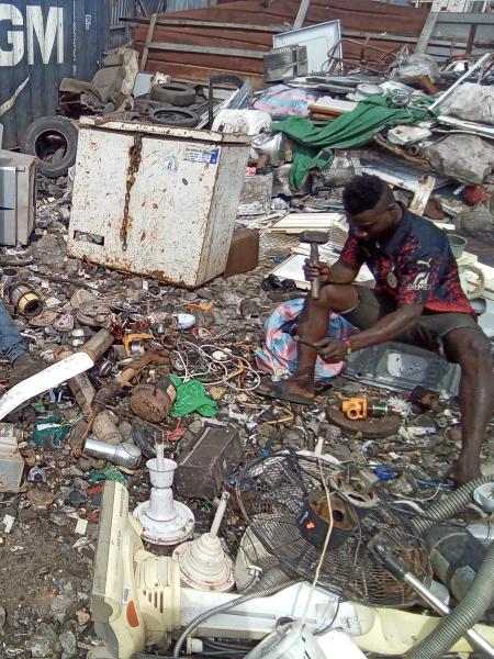A dismantler extracting valuable materials from e-waste